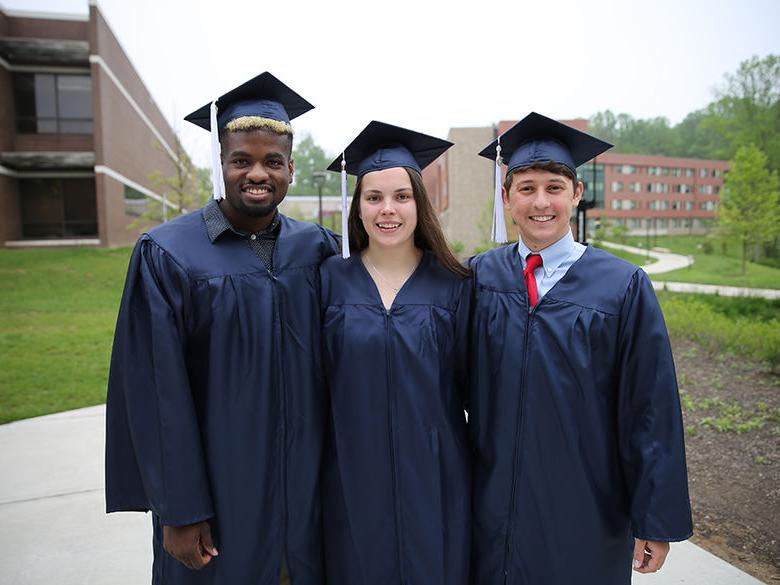 Students smiling after graduation ceremony.