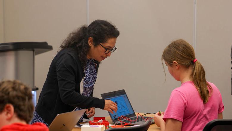 Shruti Shrestha helping student in workshop