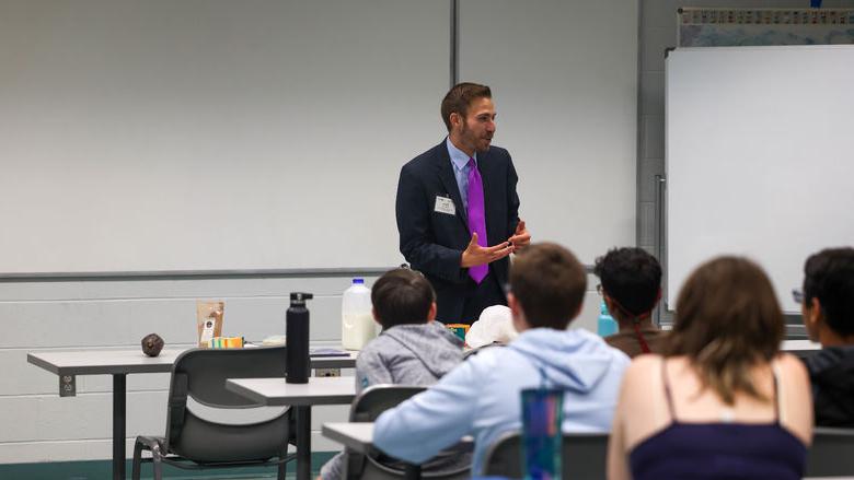 Drew Anderson speaking with students